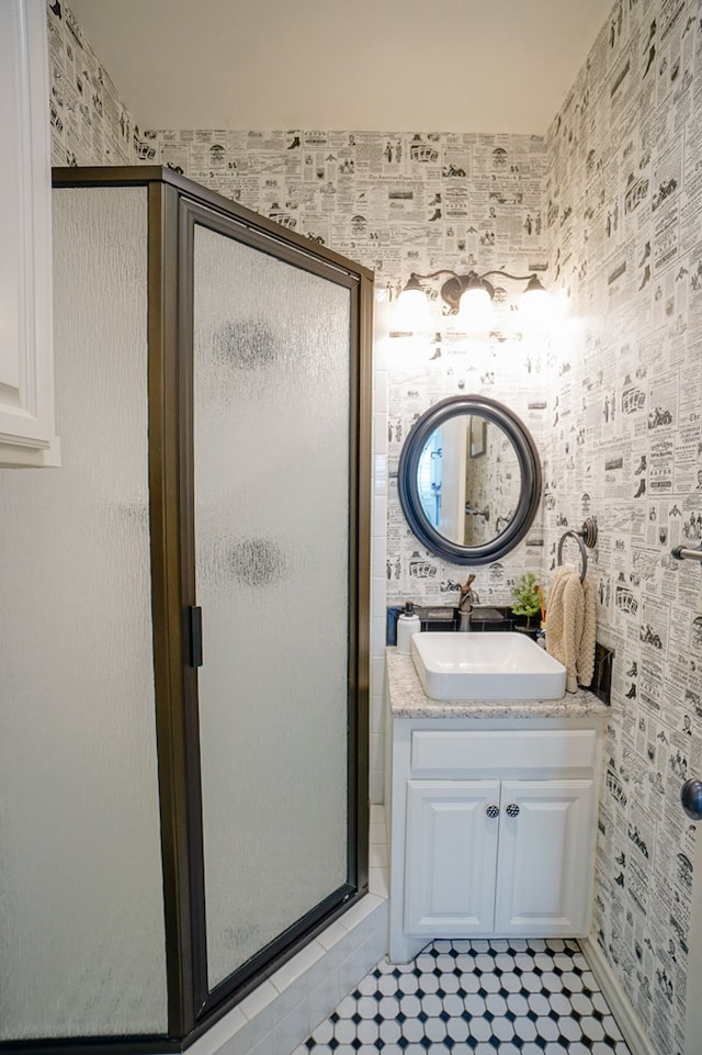 bathroom with a shower stall and vanity