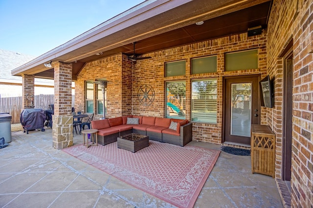 view of patio with an outdoor living space with a fire pit and fence