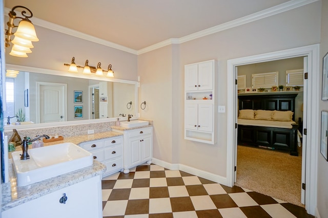 bathroom featuring crown molding, double vanity, a sink, and tile patterned floors