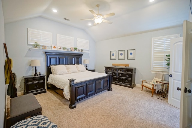 bedroom featuring lofted ceiling, a ceiling fan, visible vents, and light colored carpet