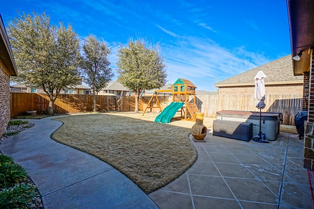 view of playground featuring a patio area, a hot tub, and a fenced backyard