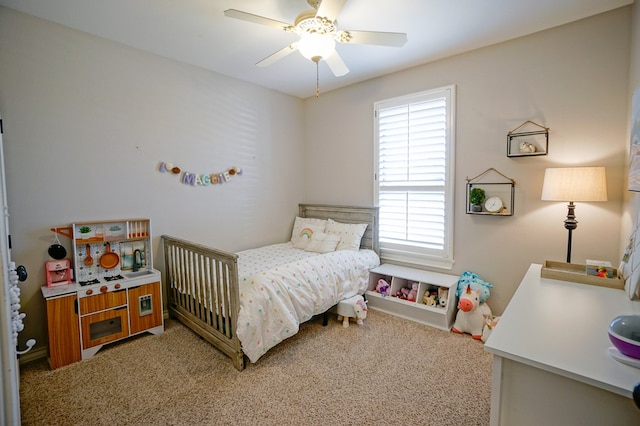 bedroom featuring ceiling fan and carpet