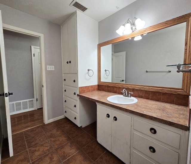 bathroom featuring visible vents, vanity, and tile patterned flooring