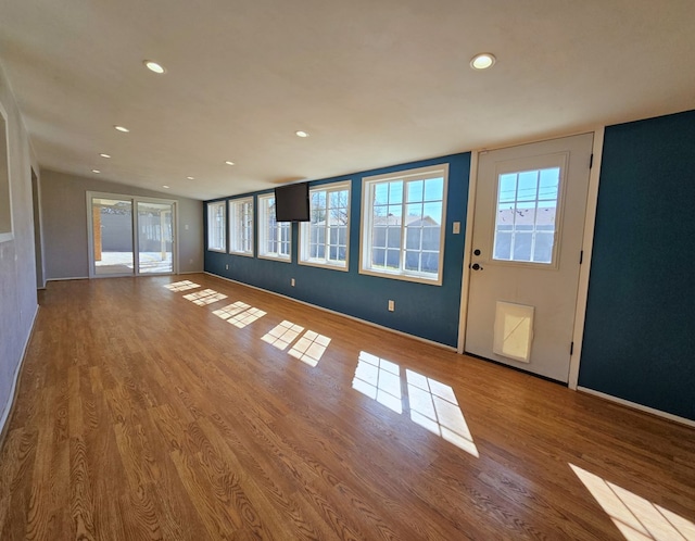 interior space with recessed lighting, baseboards, and wood finished floors