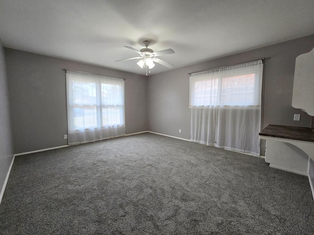 unfurnished room featuring baseboards, carpet floors, and ceiling fan