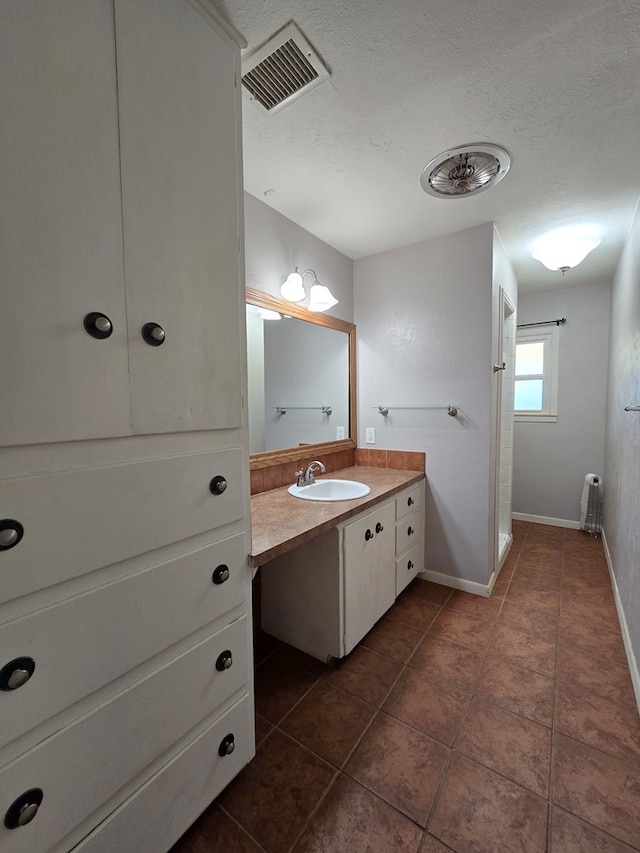 full bath with vanity, baseboards, visible vents, and tile patterned flooring