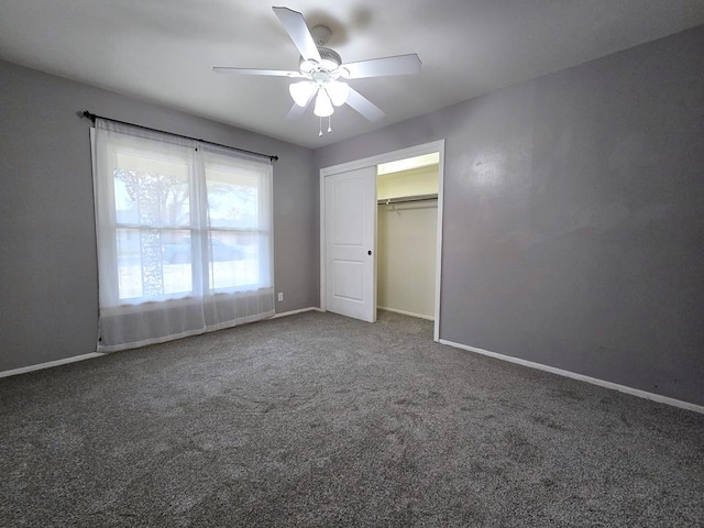 unfurnished bedroom featuring a closet, a ceiling fan, baseboards, and carpet floors