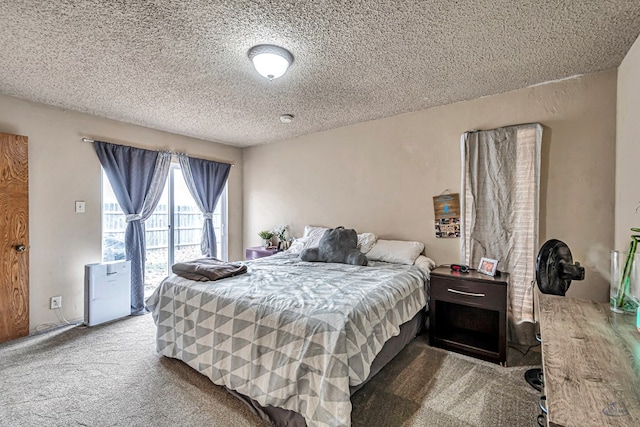 bedroom featuring carpet flooring and a textured ceiling