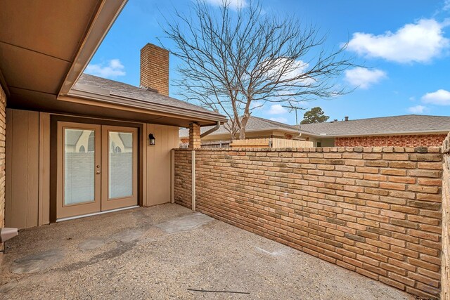 view of patio with french doors and fence