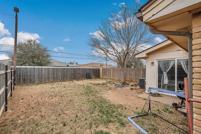 view of yard featuring central air condition unit and a fenced backyard