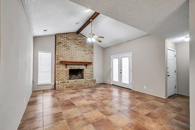 unfurnished living room featuring a brick fireplace, vaulted ceiling with beams, french doors, a textured ceiling, and a ceiling fan