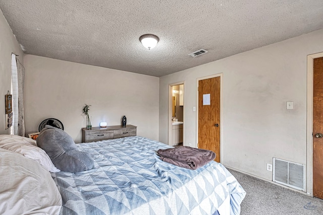 bedroom with visible vents, a textured ceiling, and carpet floors