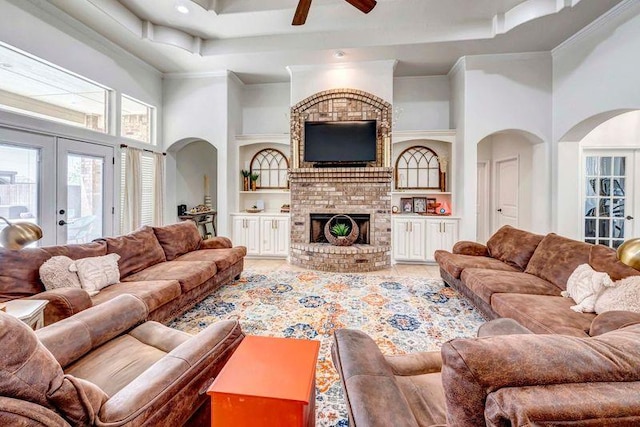 10104 E County Rd 103, Midland, TX 79706 - living room with french doors, ceiling fan, arched walkways, a high ceiling, and built in shelves