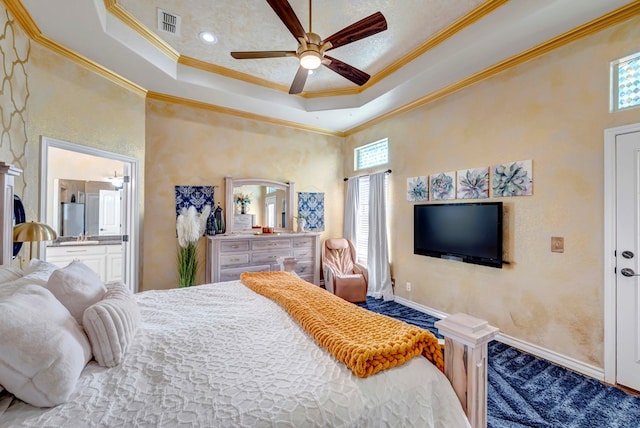 10104 E County Rd 103, Midland, TX 79706 - bedroom featuring ornamental molding, multiple windows, a tray ceiling, connected bathroom, and baseboards