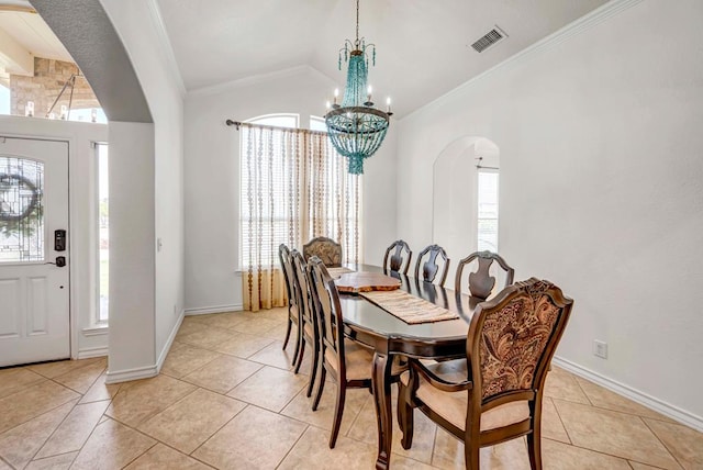 10104 E County Rd 103, Midland, TX 79706 - dining area with arched walkways, light tile patterned flooring, a chandelier, plenty of natural light, and crown molding