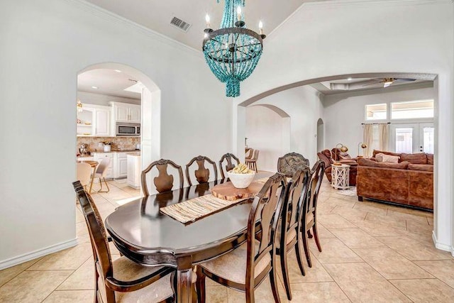10104 E County Rd 103, Midland, TX 79706 - dining area featuring arched walkways, light tile patterned floors, crown molding, and a chandelier