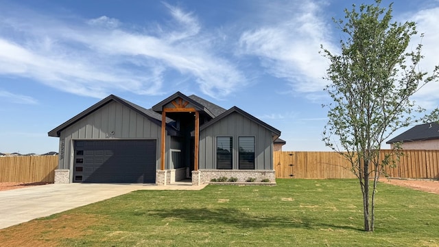 13223 E County Rd 110, Midland, TX 79706 - view of front facade featuring board and batten siding, a garage, concrete driveway, and stone siding