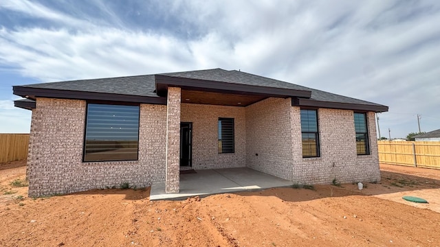 13223 E County Rd 110, Midland, TX 79706 - back of house featuring a patio area, brick siding, and roof with shingles