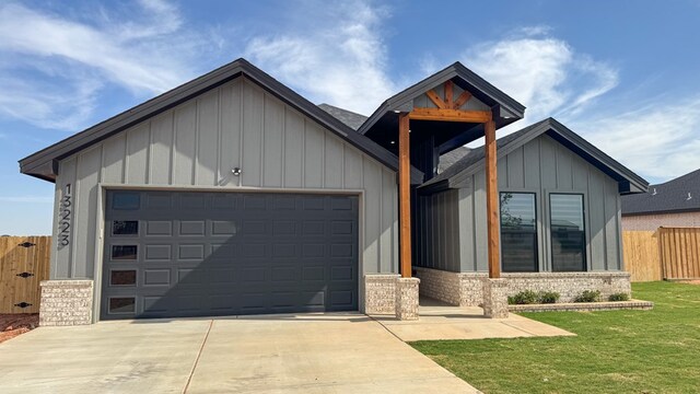 13223 E County Rd 110, Midland, TX 79706 - view of front facade featuring board and batten siding, concrete driveway, brick siding, and an attached garage