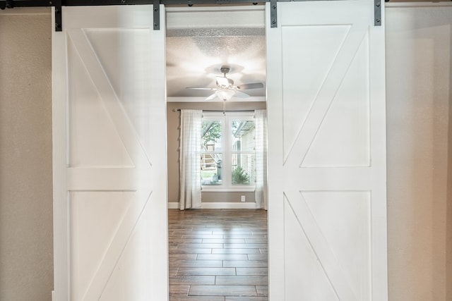 2205 Boyd Ave, Midland, TX 79705 - hallway with a barn door, wood finished floors, and crown molding