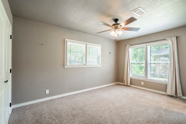 2205 Boyd Ave, Midland, TX 79705 - carpeted empty room featuring healthy amount of natural light, a textured ceiling, and a ceiling fan
