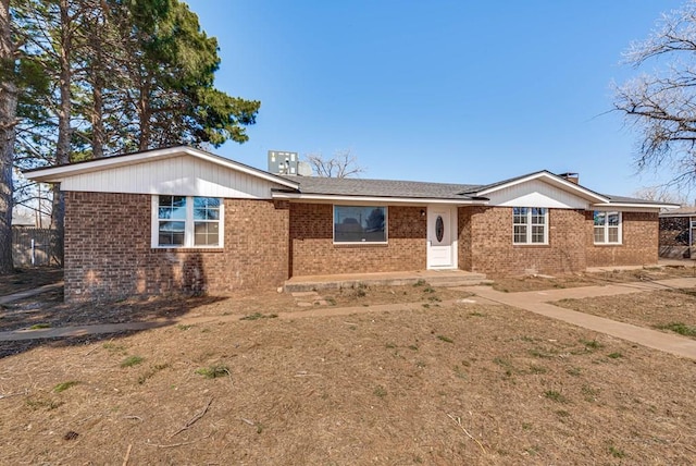 single story home featuring brick siding