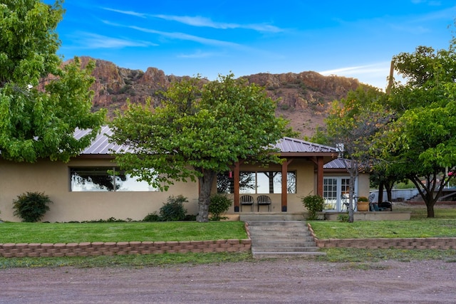 view of front facade with a mountain view and a front lawn