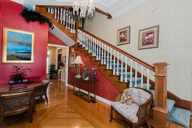 stairway featuring baseboards, a towering ceiling, visible vents, and a notable chandelier