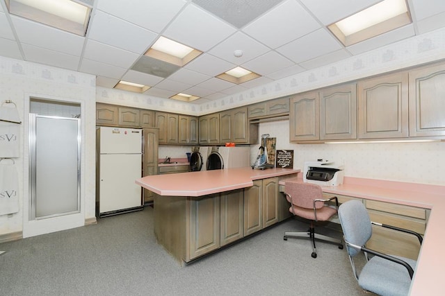 office featuring independent washer and dryer, a sink, a paneled ceiling, and wallpapered walls