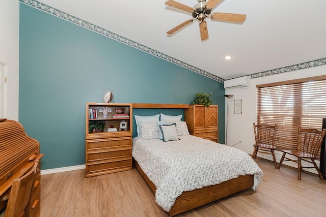 bedroom with light wood finished floors, baseboards, ceiling fan, a wall mounted air conditioner, and recessed lighting