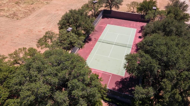 view of tennis court featuring fence