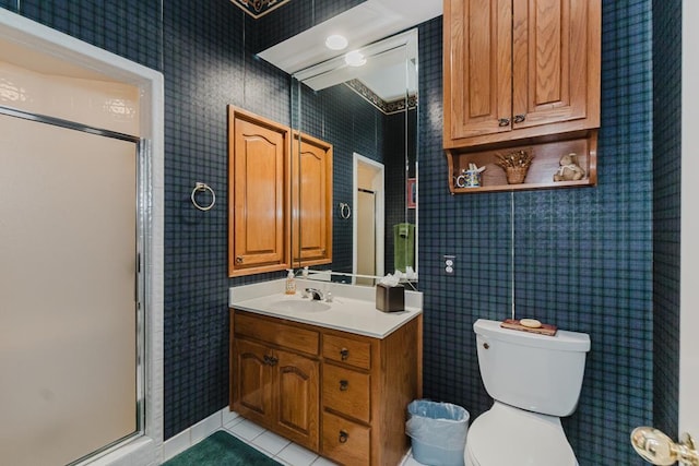 full bath with tile patterned flooring, toilet, vanity, a stall shower, and wallpapered walls