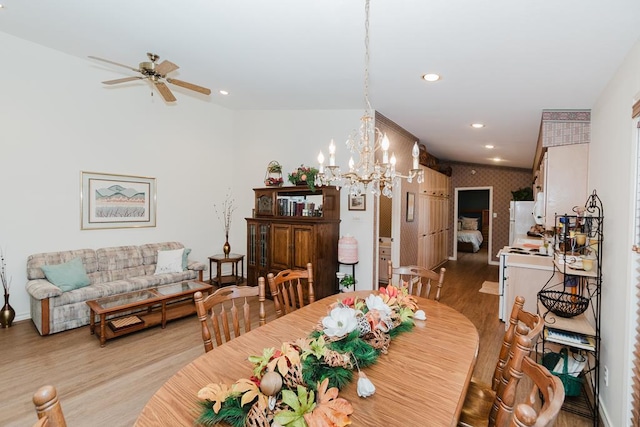 dining area with ceiling fan with notable chandelier, light wood-type flooring, baseboards, and recessed lighting