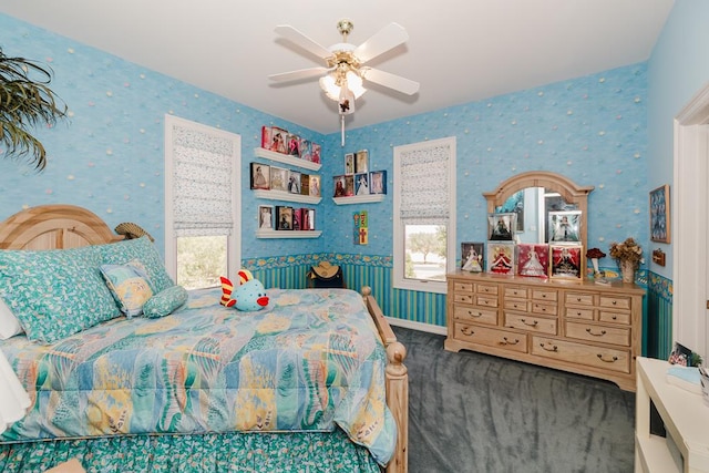 bedroom featuring wallpapered walls, baseboards, and a ceiling fan