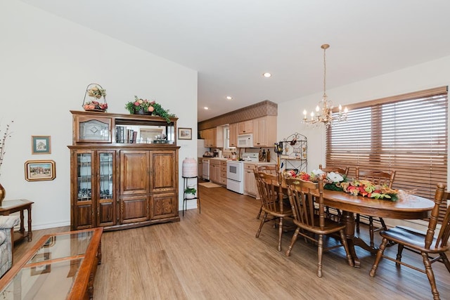 dining area featuring light wood-style floors, baseboards, a notable chandelier, and recessed lighting