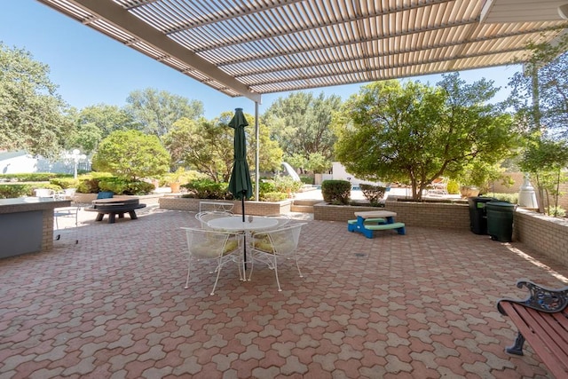 view of patio with an outdoor fire pit, a pergola, and outdoor dining space