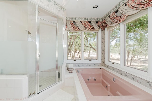 full bathroom with a shower stall and a tub with jets