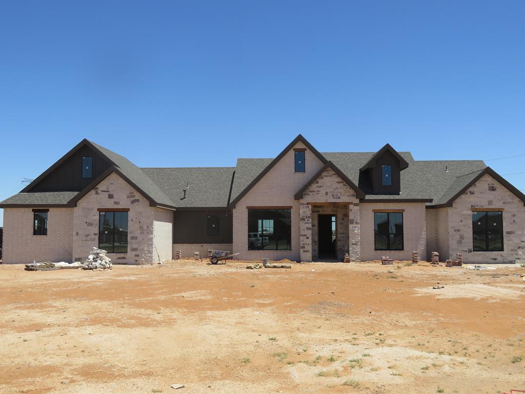 2701 S County Rd 1092, Midland, TX 79706 - view of front of house with brick siding and roof with shingles