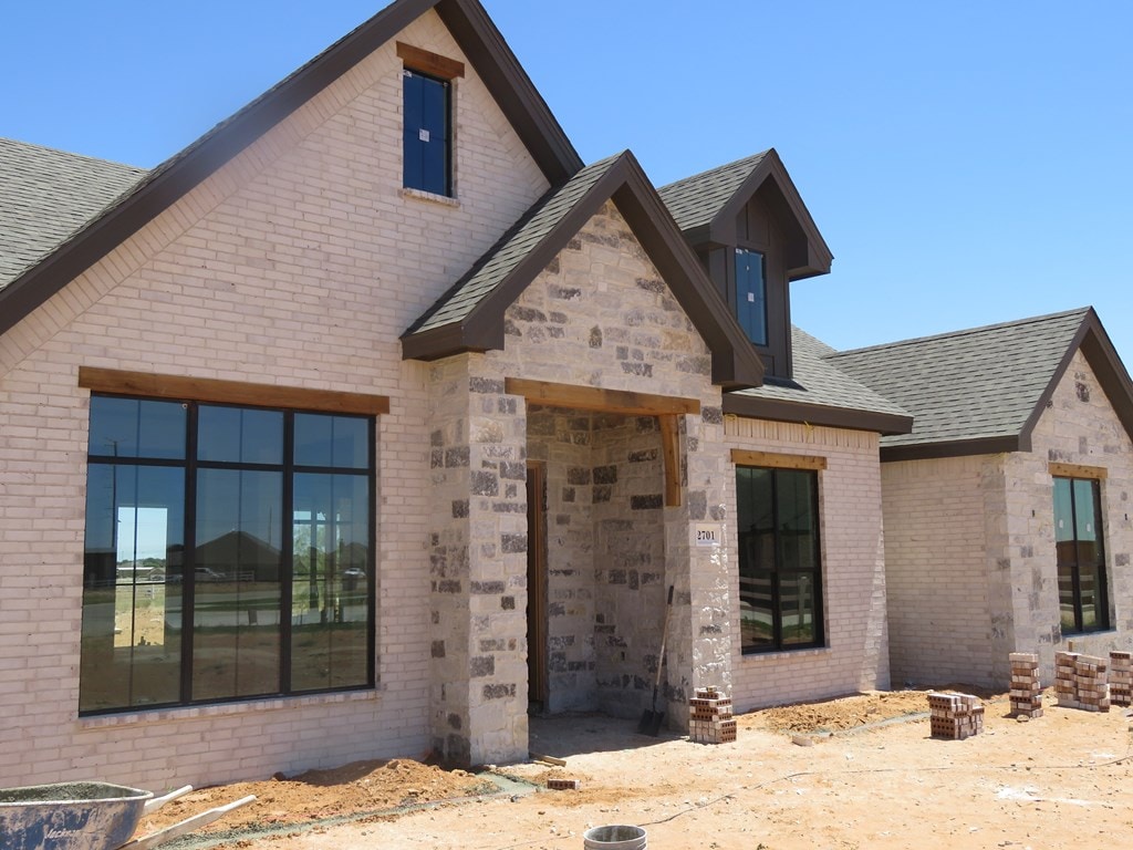 2701 S County Rd 1092, Midland, TX 79706 - view of front facade featuring brick siding and a shingled roof