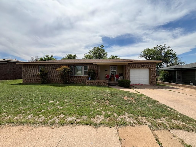 3103 Hill Ave, Snyder, TX 79549 - ranch-style home featuring a garage, brick siding, concrete driveway, and a front lawn