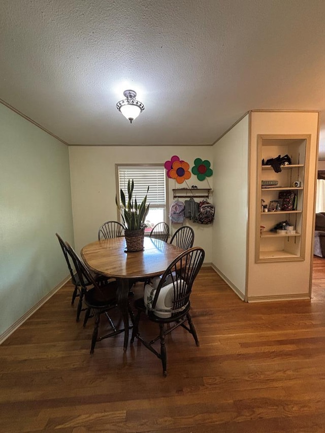 3103 Hill Ave, Snyder, TX 79549 - dining area with a textured ceiling, wood finished floors, and baseboards