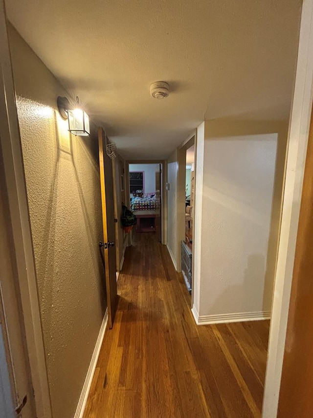 3103 Hill Ave, Snyder, TX 79549 - hall with wood finished floors, baseboards, and a textured wall