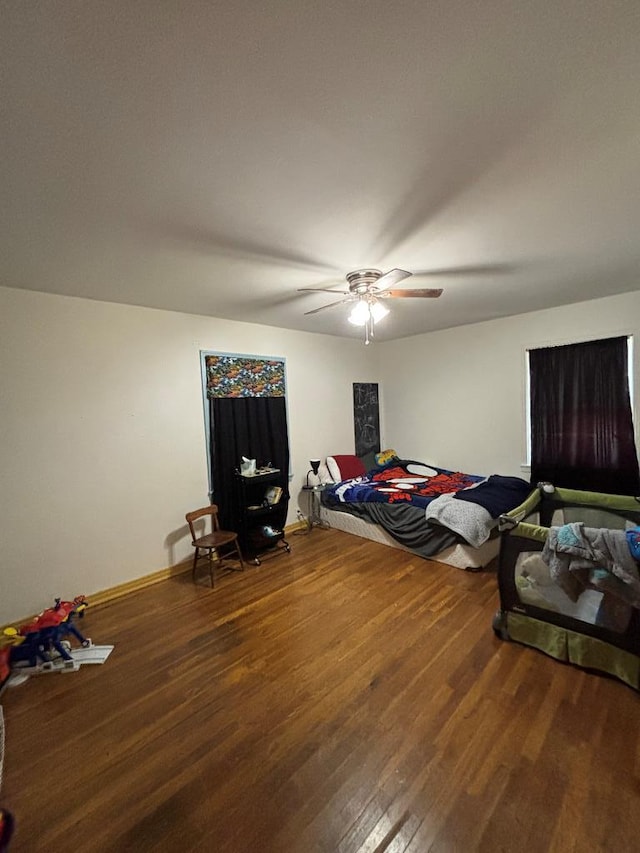 3103 Hill Ave, Snyder, TX 79549 - bedroom with wood finished floors, a ceiling fan, and baseboards