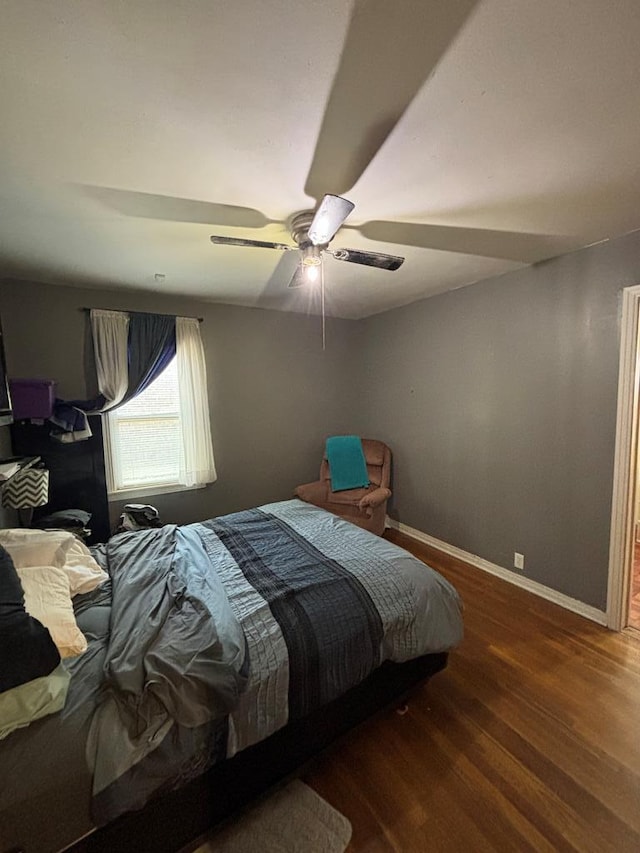 3103 Hill Ave, Snyder, TX 79549 - bedroom with wood finished floors, baseboards, and a ceiling fan