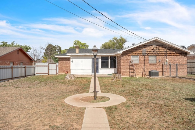 2502 Ann Dr, Big Spring, TX 79720 - rear view of property featuring brick siding, a gate, and central AC unit