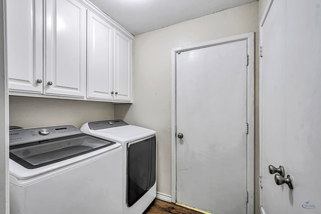 laundry area featuring independent washer and dryer, dark wood-style floors, and cabinet space