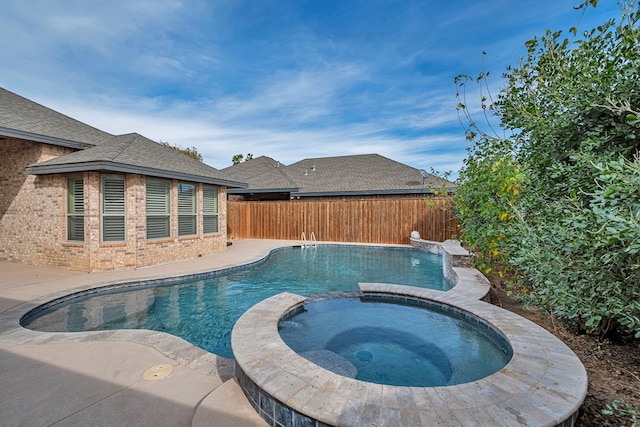 view of swimming pool with an in ground hot tub