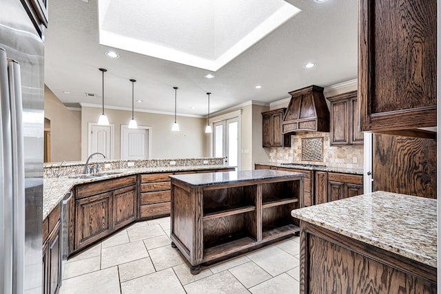 kitchen with sink, dark brown cabinets, stainless steel appliances, custom exhaust hood, and kitchen peninsula