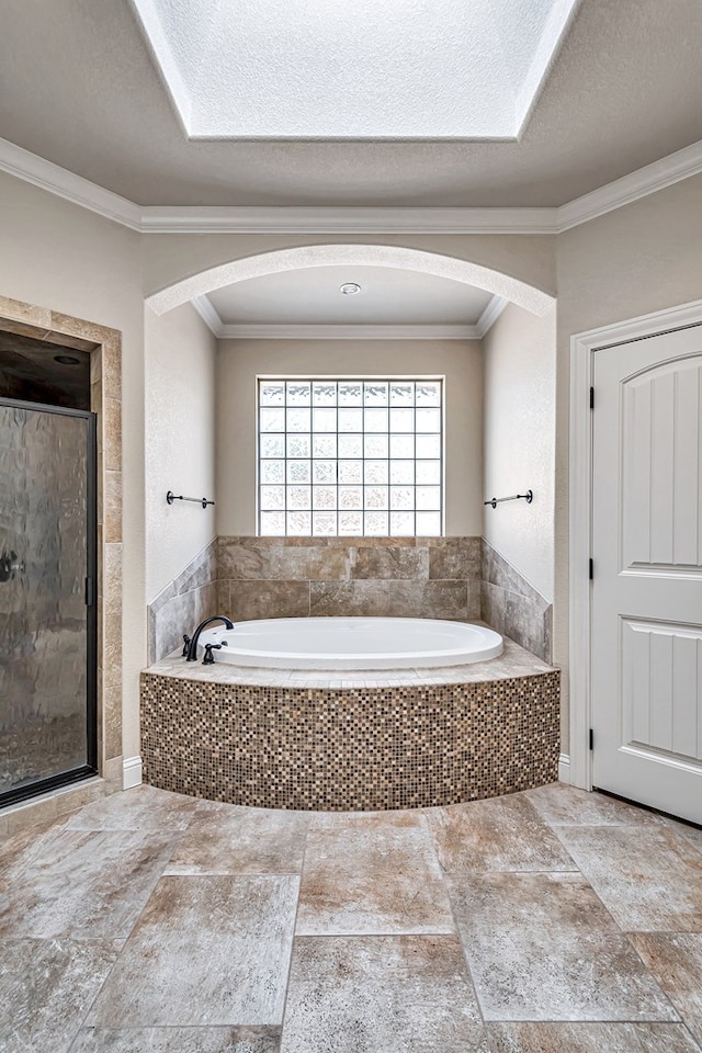 bathroom with ornamental molding, separate shower and tub, and a textured ceiling