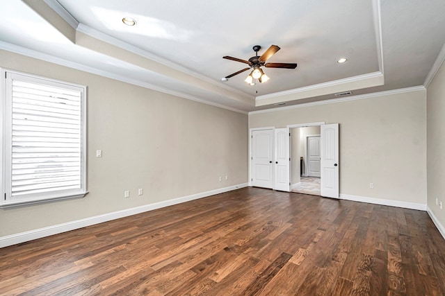 unfurnished bedroom featuring a raised ceiling, crown molding, ceiling fan, and dark hardwood / wood-style flooring